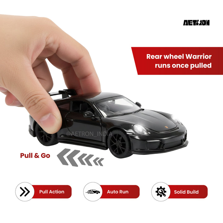 Hand pulling back the Aetron 911 GT3 1:32 diecast model to wind the pull-back motor